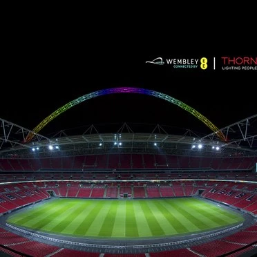 Wembley stadion v noci s rozsvíceným hřištěm.
