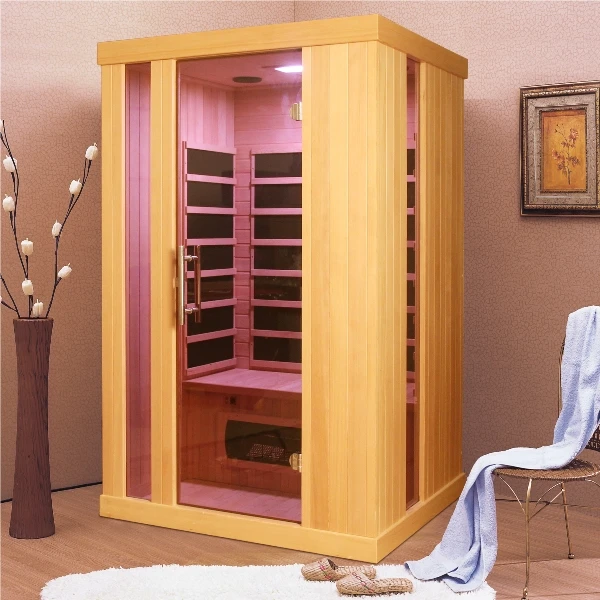Dřevěná infra sauna v interiéru s otevřenými dveřmi.